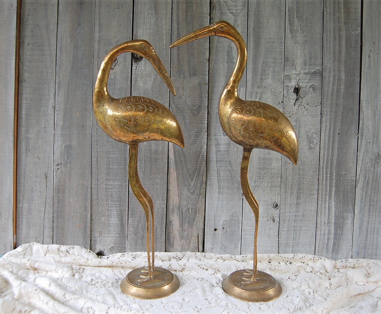 Tall brass flamingos